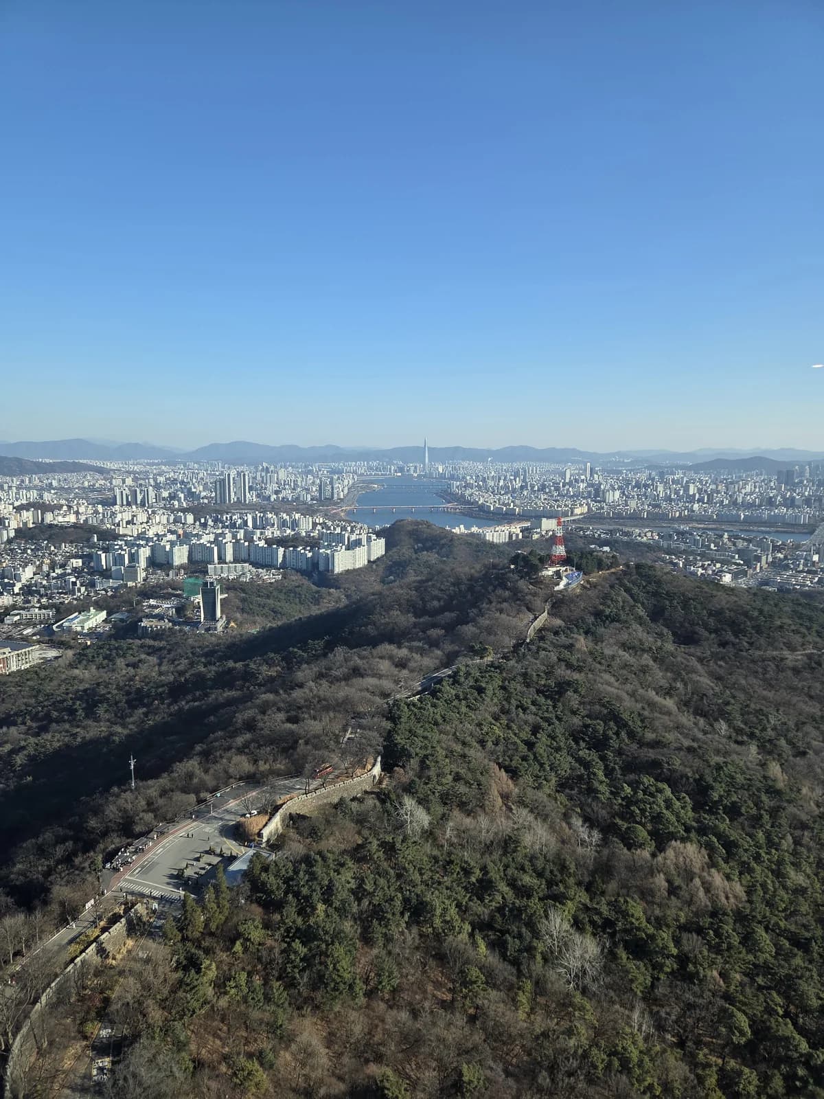 Panoramic city skyline from a winter hilltop