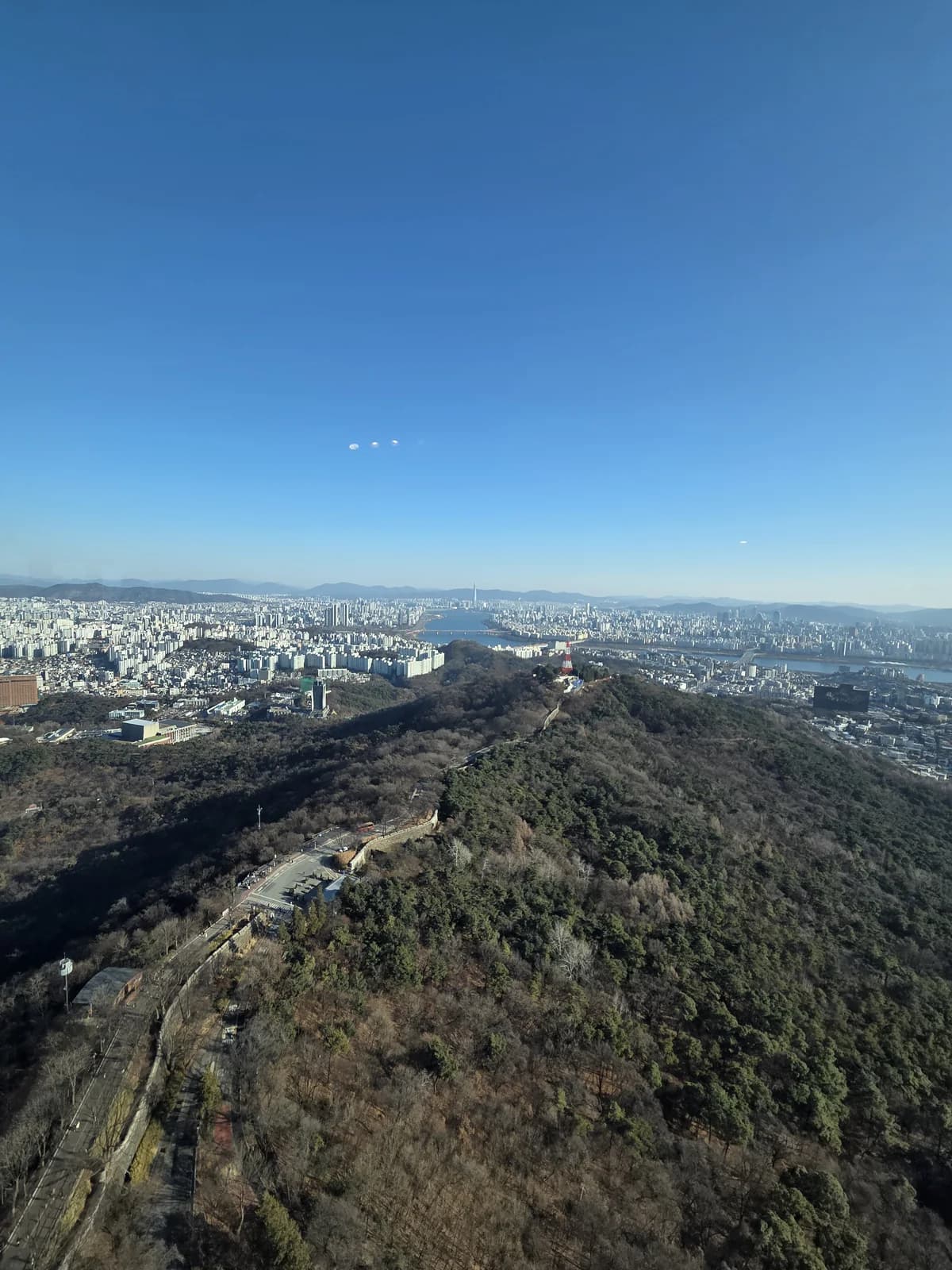Panoramic city skyline from a winter hilltop