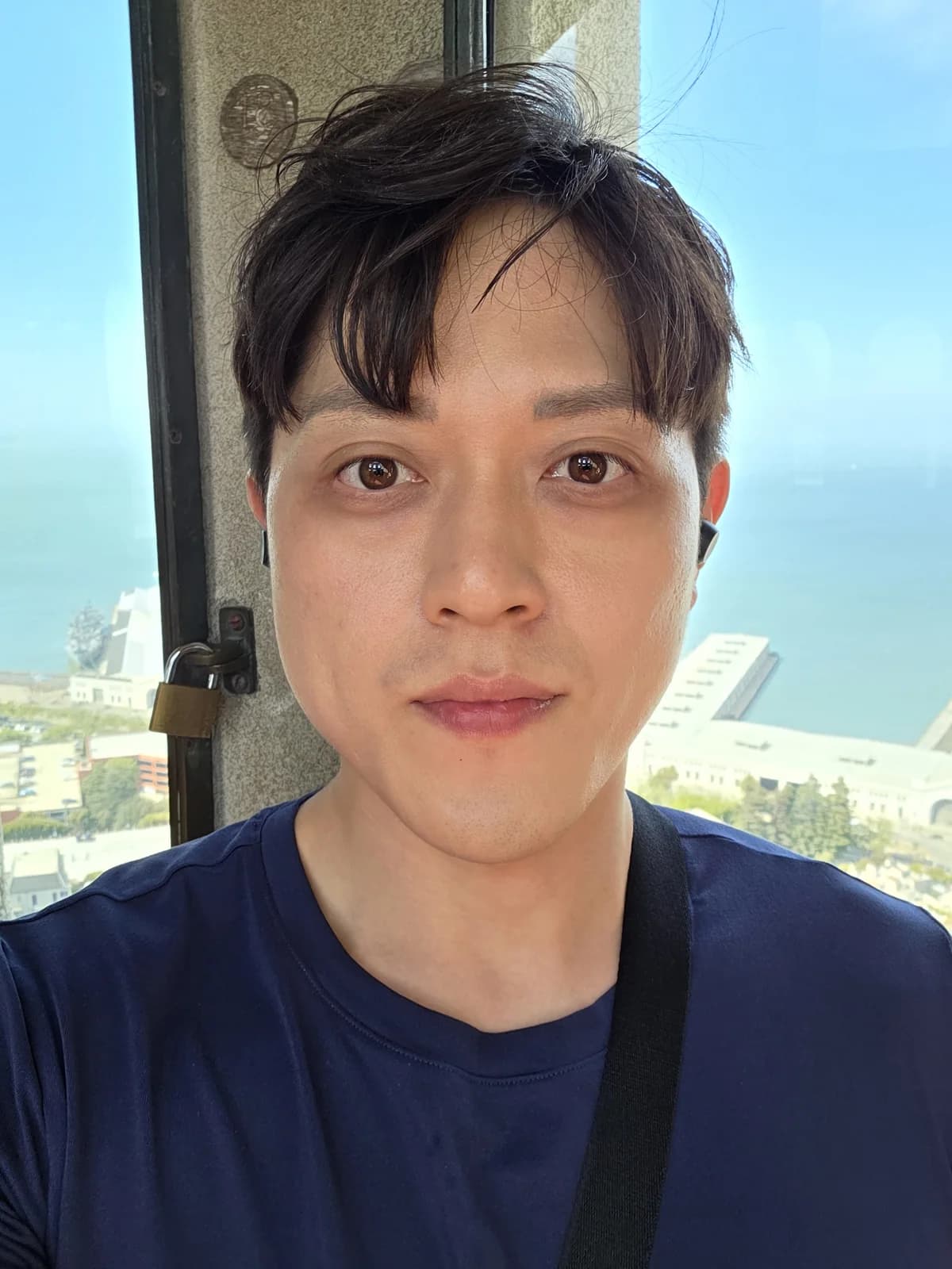 Close founder portrait with an ocean-and-city backdrop