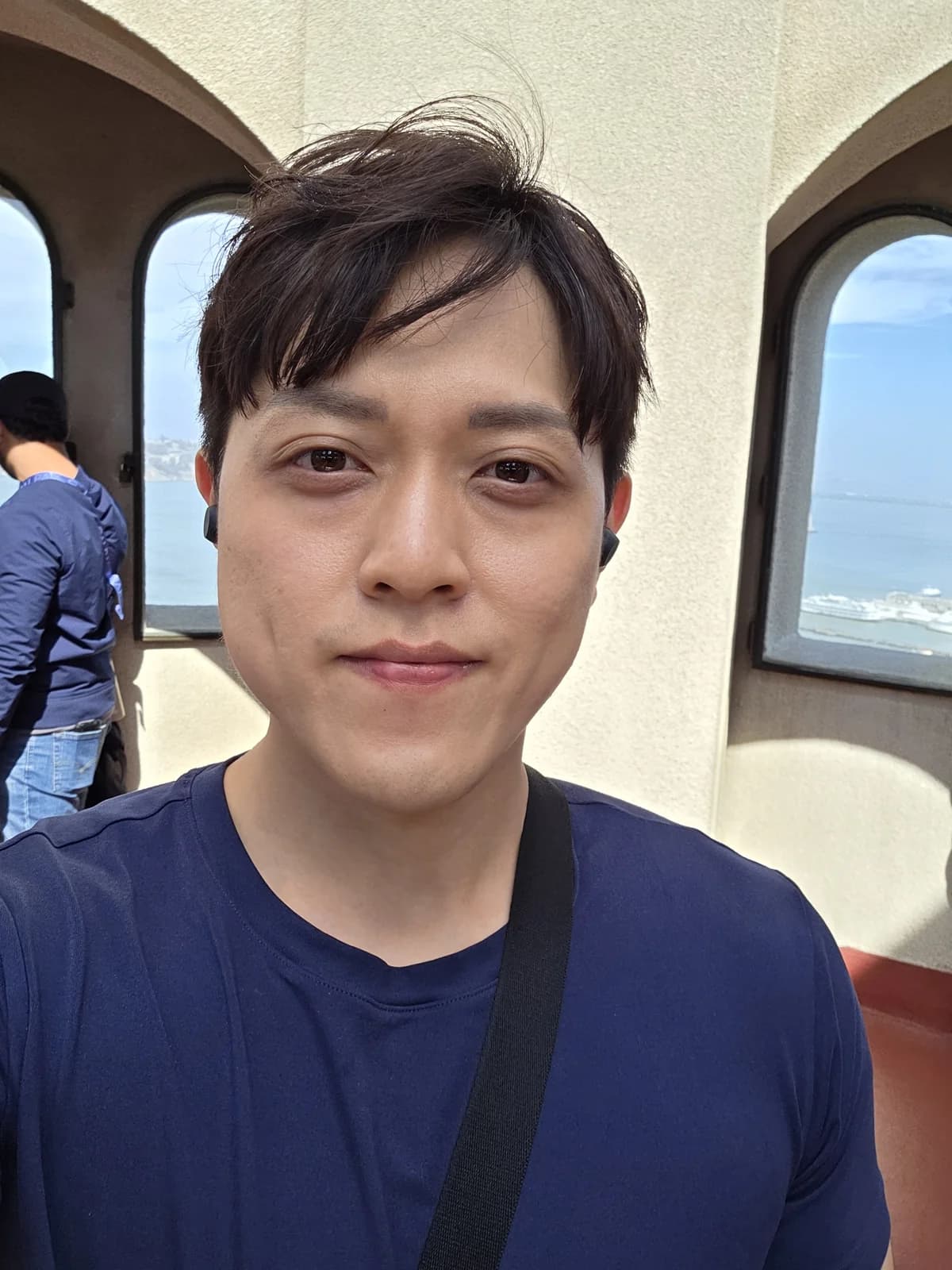 Close founder portrait with an ocean-and-city backdrop