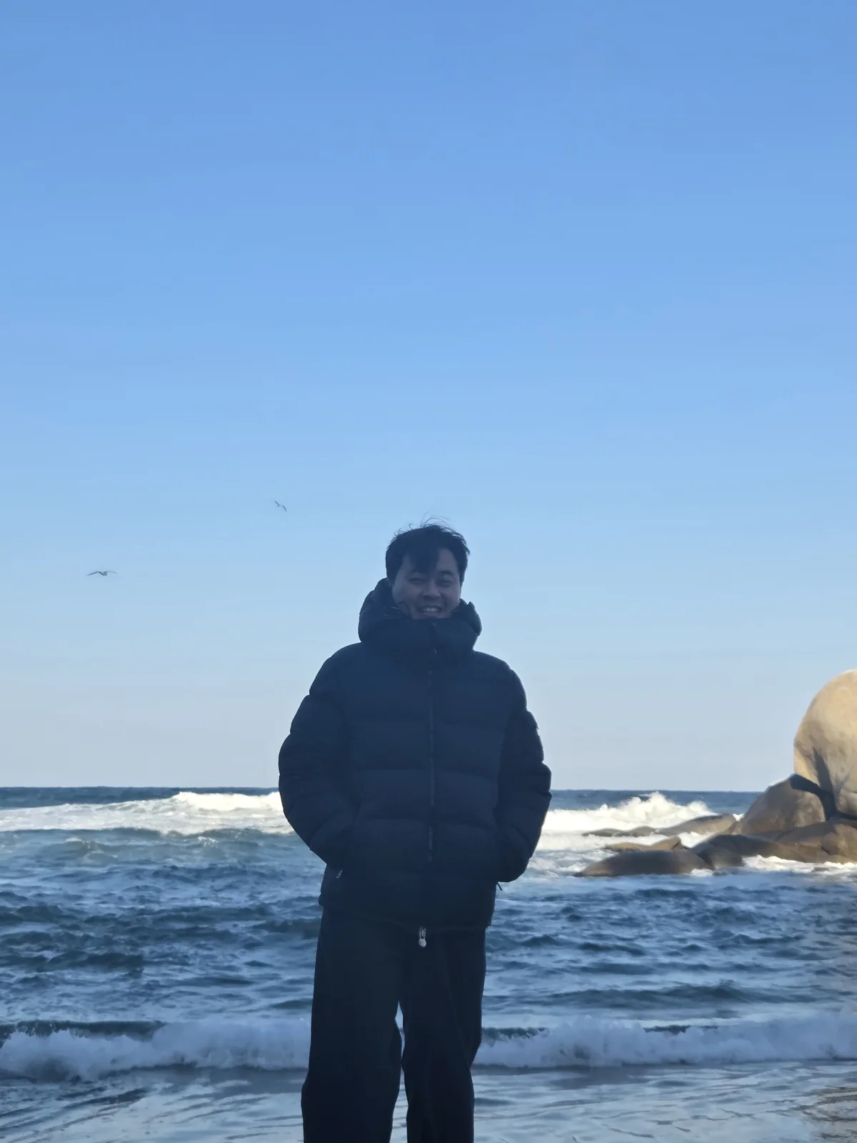 Founder standing on a cold beach in winter outerwear