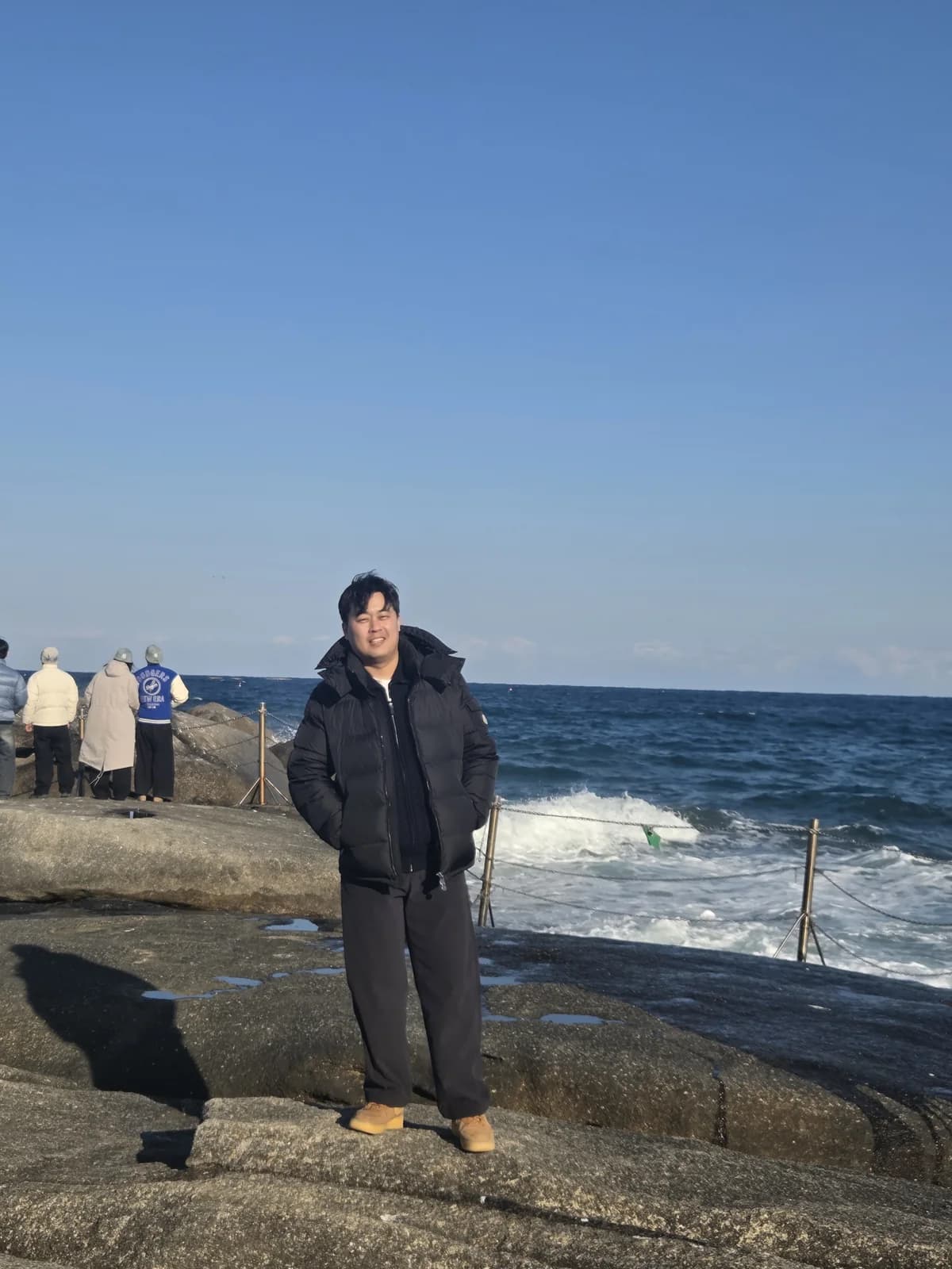 Founder by the winter sea in a dark jacket
