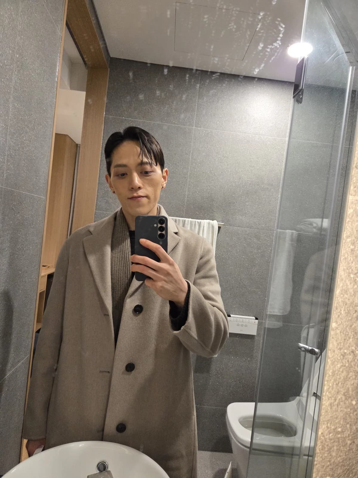 Founder mirror portrait in a beige coat