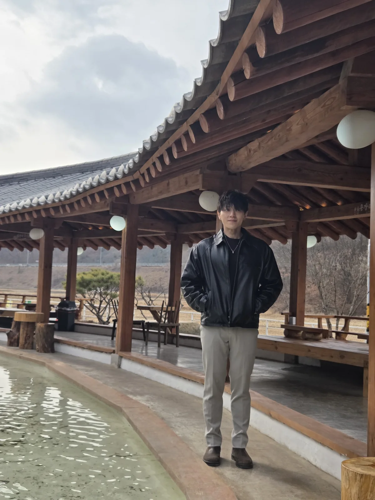 Full-body founder portrait at a hanok courtyard