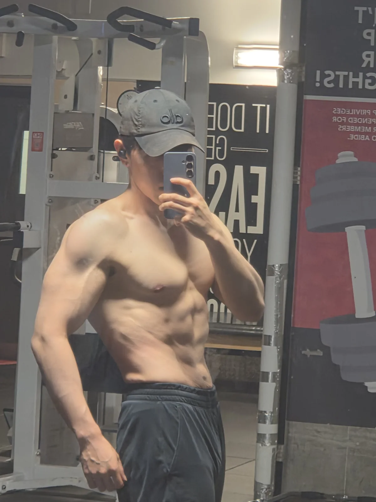 Founder gym mirror physique check-in with visible abdominal definition