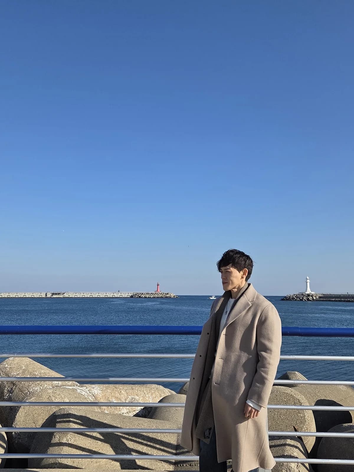 Founder lifestyle portrait by the seaside in a beige coat
