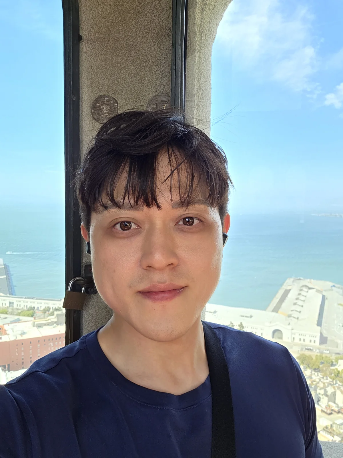 Close founder portrait with an ocean-and-city backdrop